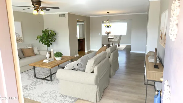 a living room with furniture and a chandelier