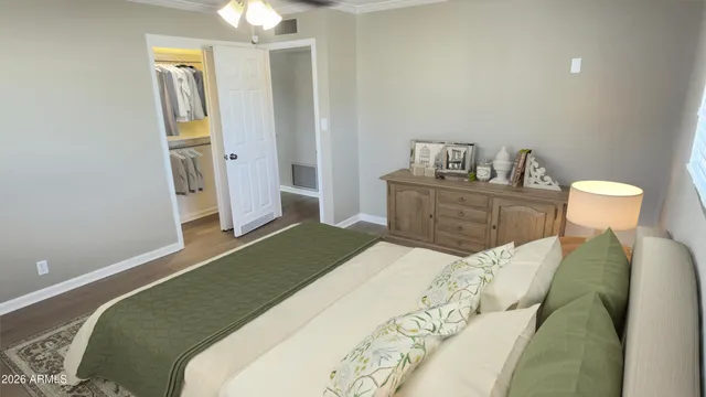 a bedroom with a bed and a chandelier