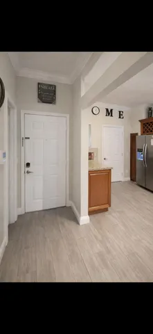 a view of empty room with wooden floor