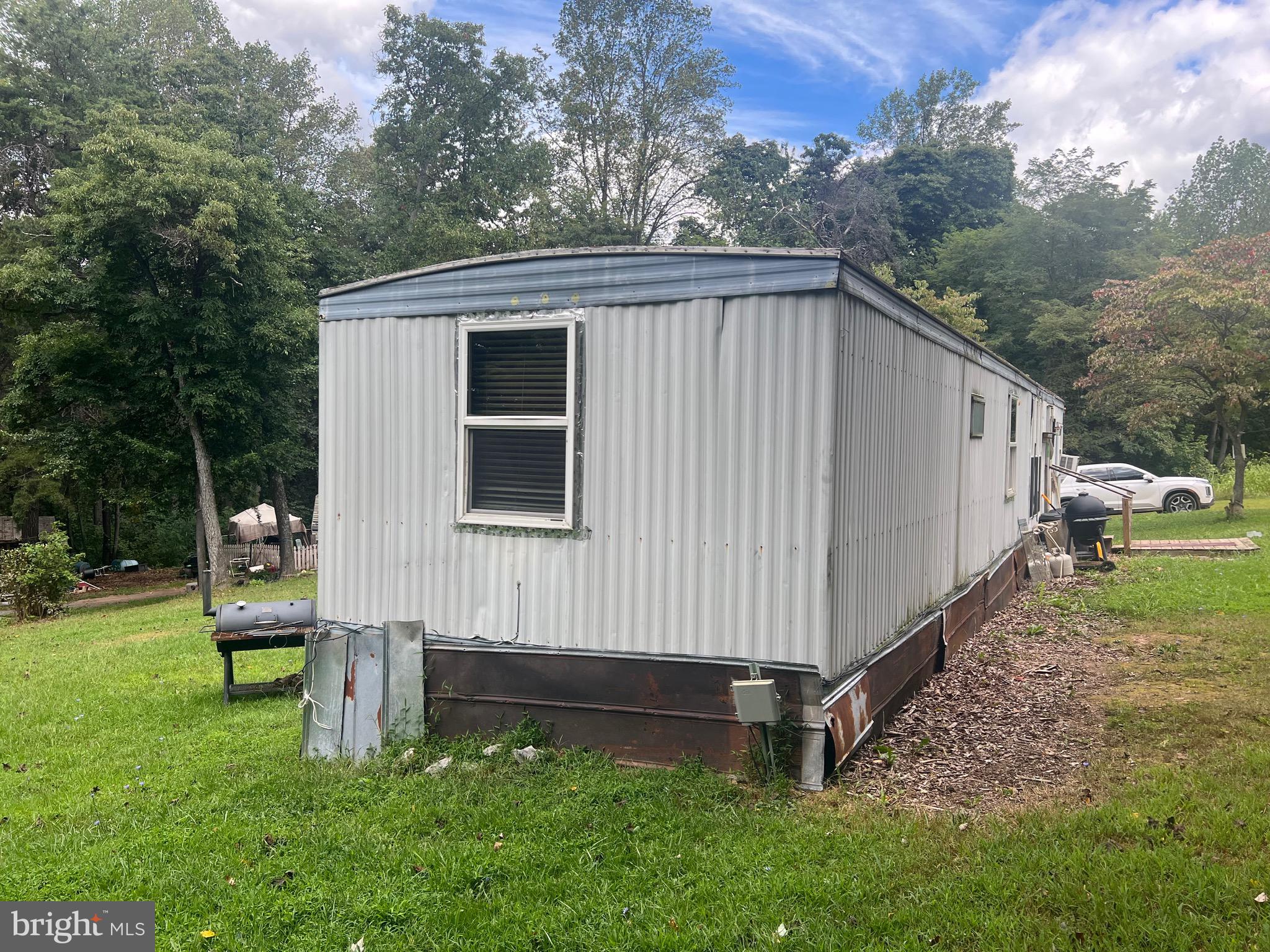 22322 Cacapon Road Paw Paw, WV 25434 - Photo 3 of 11 a view of backyard with small cabin and a chair