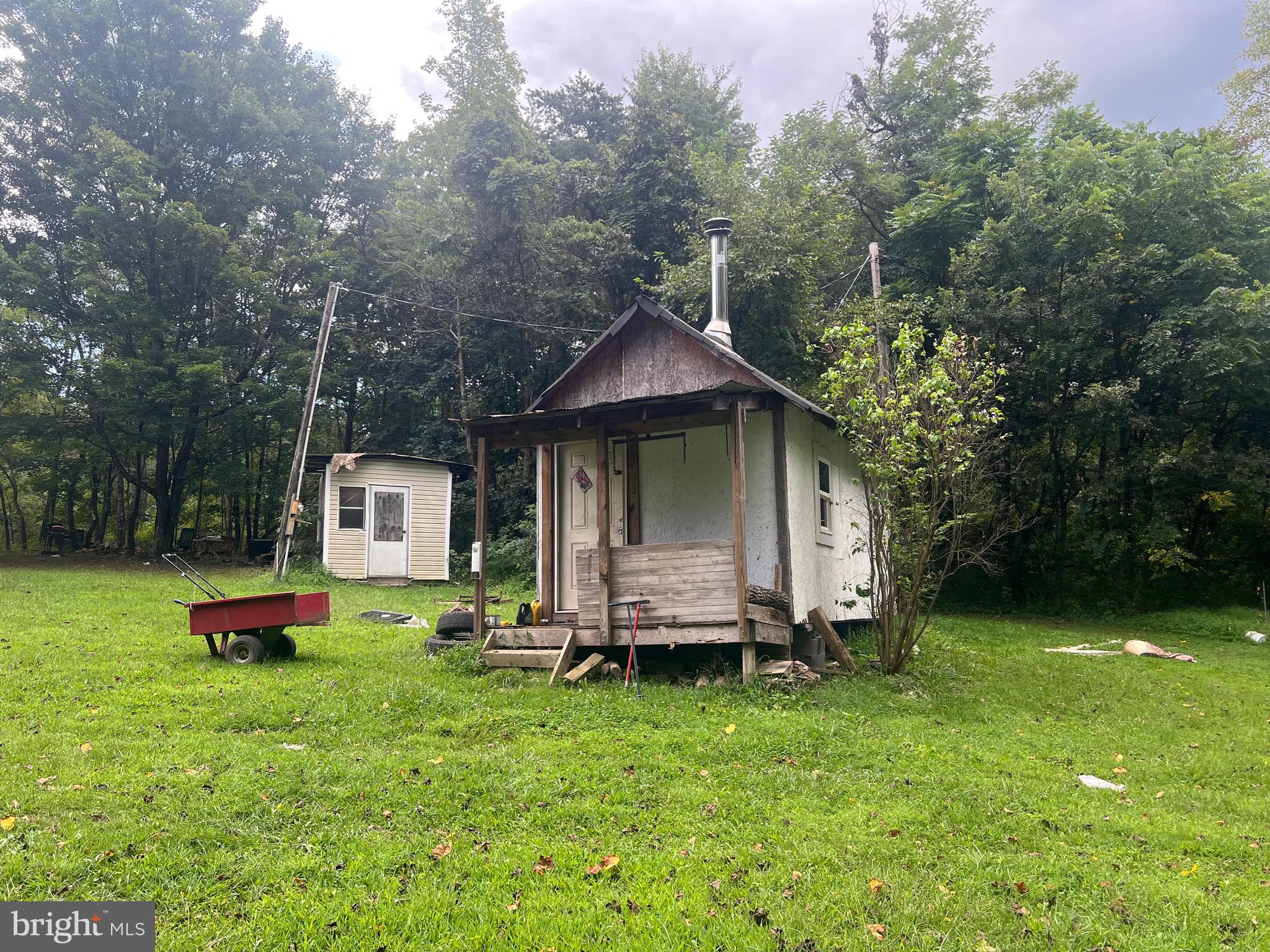 22322 Cacapon Road Paw Paw, WV 25434 - Photo 9 of 11 a front view of a house with swing and a slide