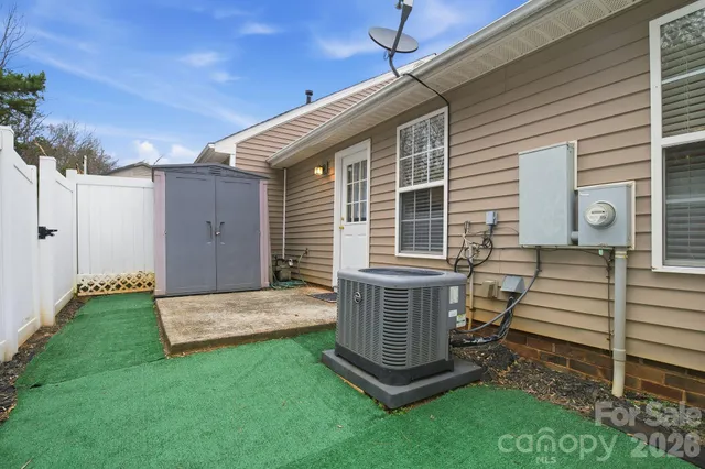 a view of a chair and table in backyard of the house