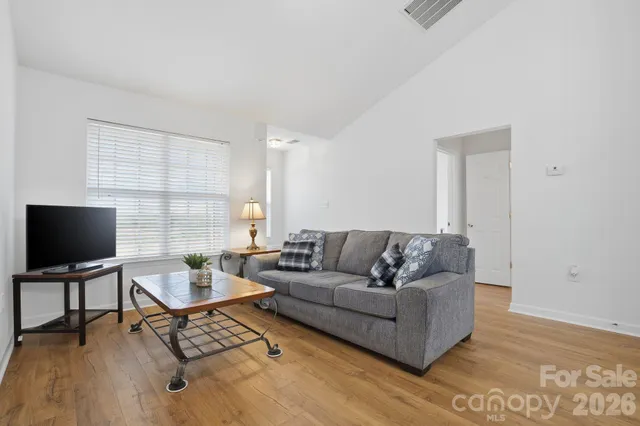 a living room with furniture and a flat screen tv