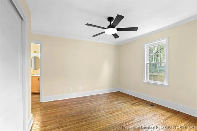 a view of a hallway with entryway wooden floor and front door