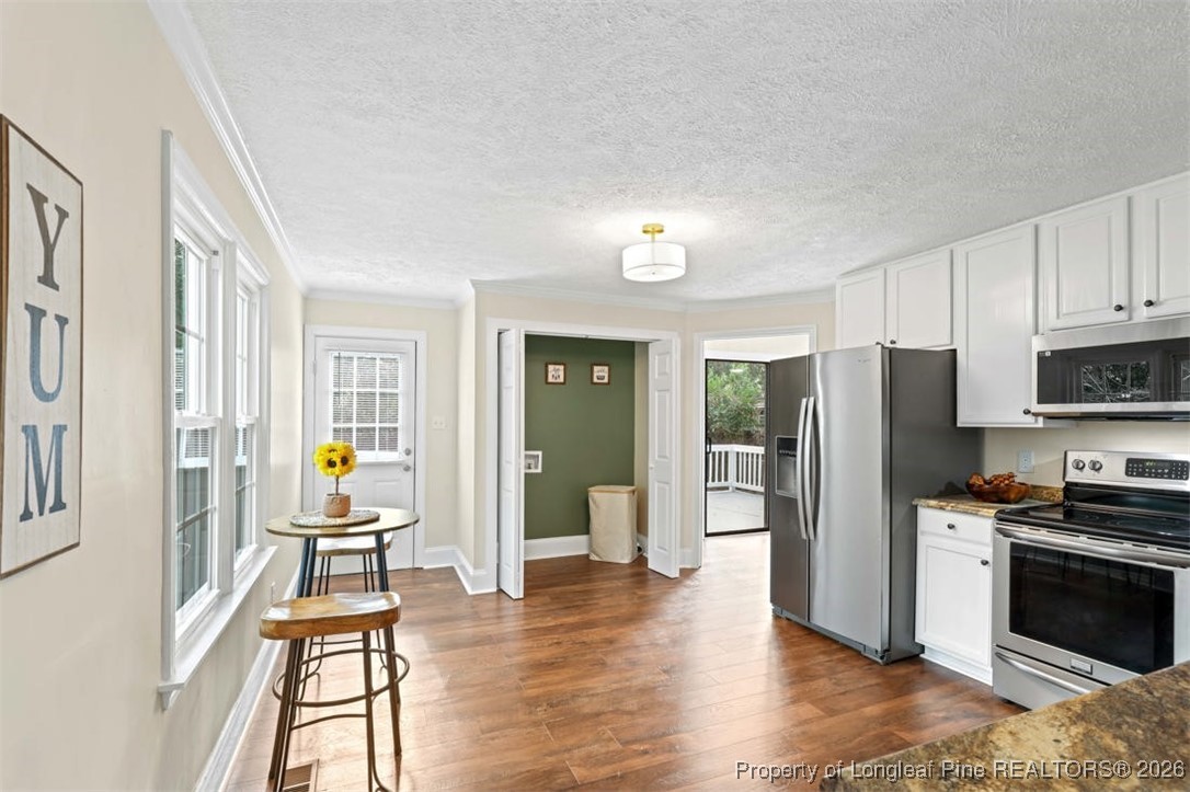 1605 Morganton Road Fayetteville, NC 28305 - Photo 16 of 30 a kitchen with granite countertop a refrigerator and wooden floor