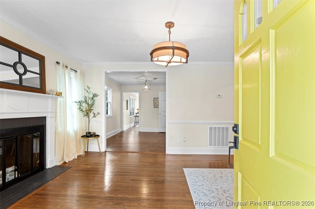 1605 Morganton Road Fayetteville, NC 28305 - Photo 7 of 30 a view of a hallway with wooden floor and a fireplace