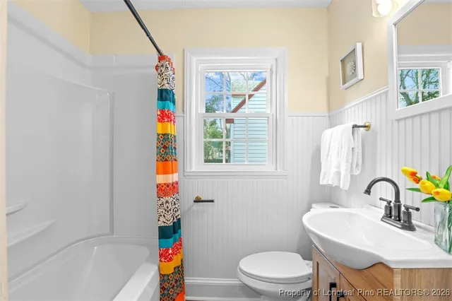 a kitchen with granite countertop a refrigerator and wooden floor