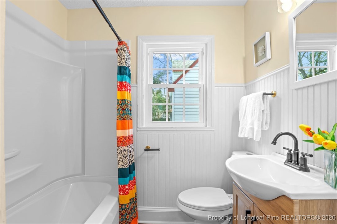 1605 Morganton Road Fayetteville, NC 28305 - Photo 10 of 30 a bathroom with a sink a toilet and a window