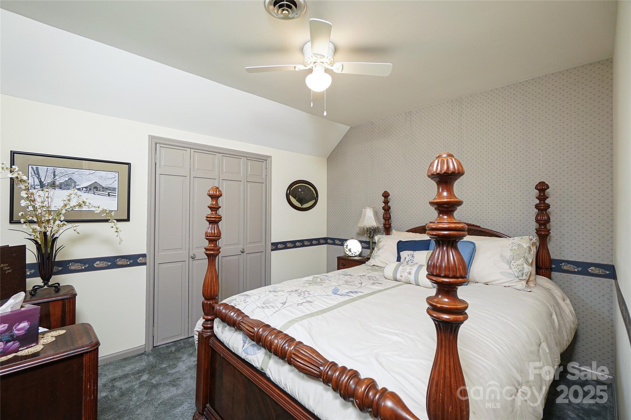 1115 John Short Road Indian Land, SC 29707 - Photo 26 of 48 a bedroom with a bed and a chandelier