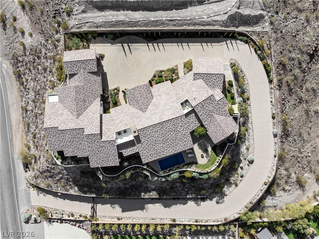 1123 Christian Road Henderson, NV 89002 - Photo 89 of 94 An aerial perspective showcases the home's sprawling layout with a private pool and winding driveways.