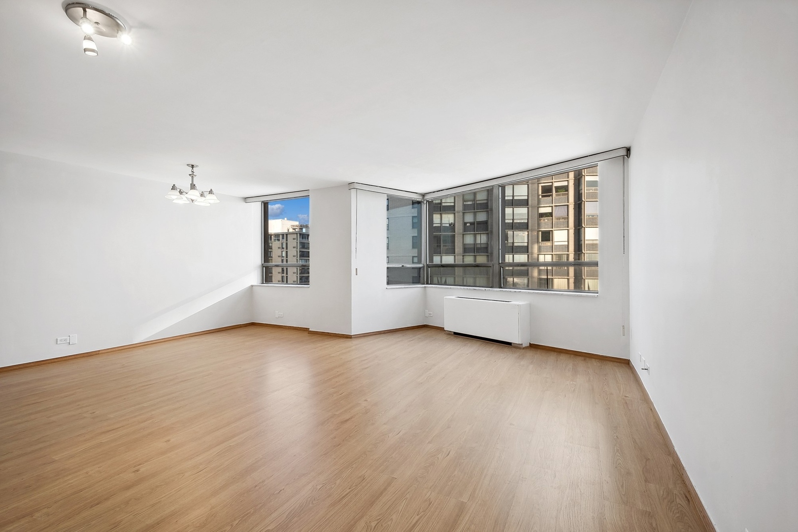 5701 North Sheridan Road, Unit 15R Chicago, IL 60660 - Photo 3 of 21 wooden floor in an empty room with a window