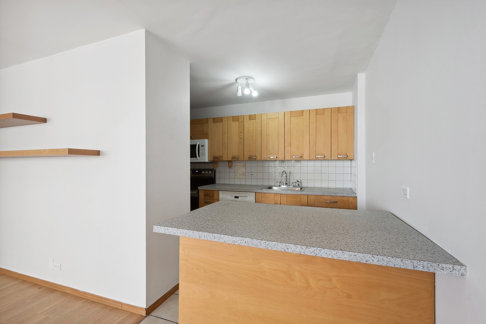 5701 North Sheridan Road, Unit 15R Chicago, IL 60660 - Photo 8 of 21 a view of kitchen with wooden floor