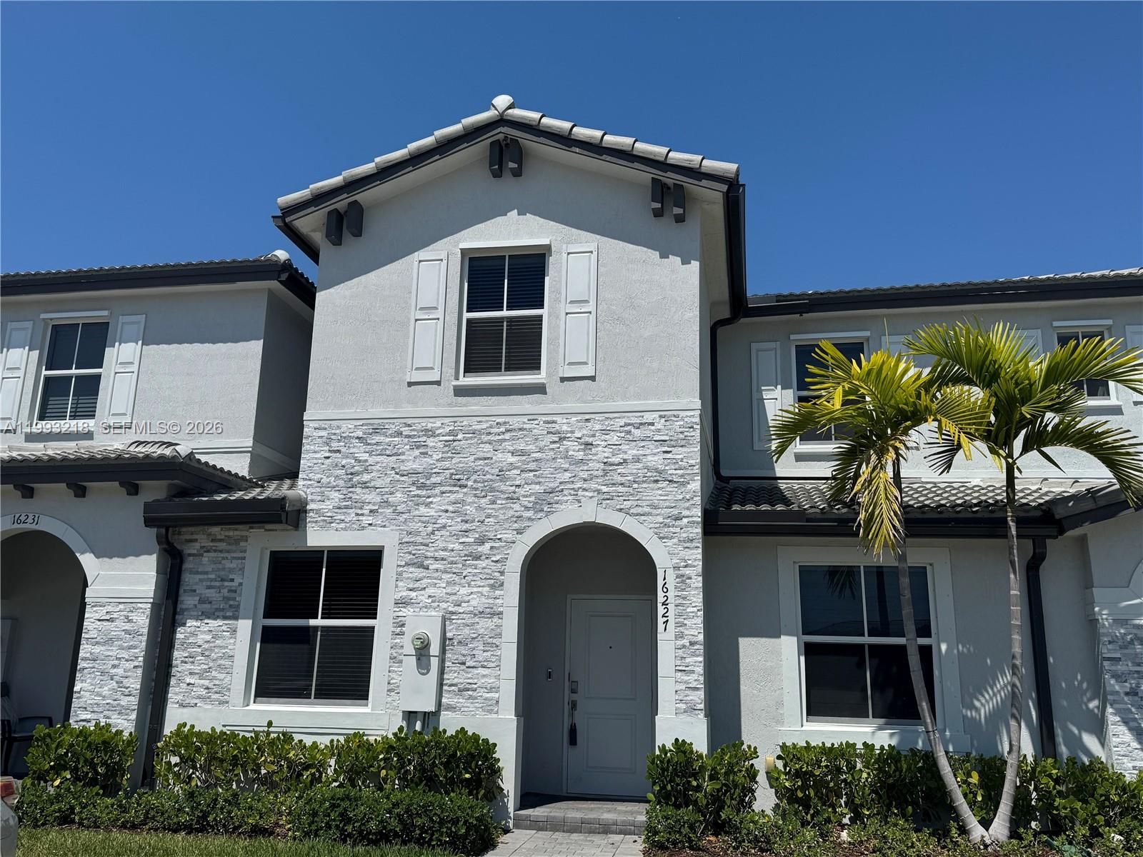 a front view of a house with garden