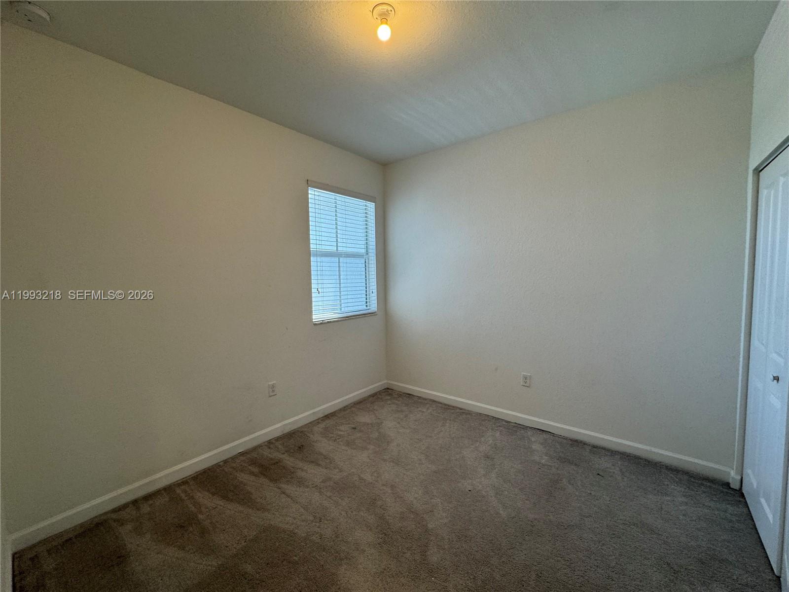 16227 Southwest 292nd Street Homestead, FL 33033 - Photo 15 of 28 an empty room with a empty space and window