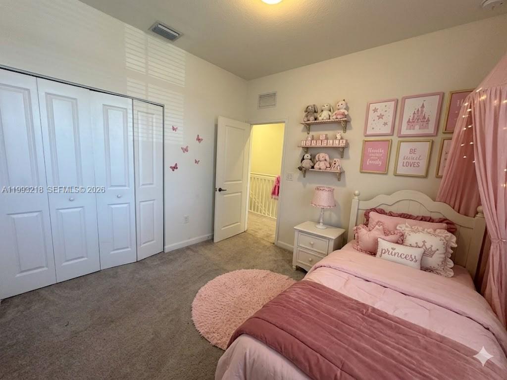 16227 Southwest 292nd Street Homestead, FL 33033 - Photo 16 of 28 a bedroom with a bed and a walk in closet