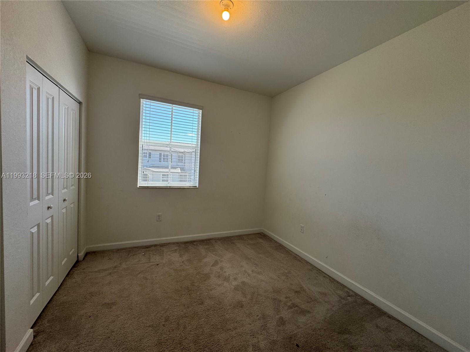16227 Southwest 292nd Street Homestead, FL 33033 - Photo 21 of 28 an empty room with a window