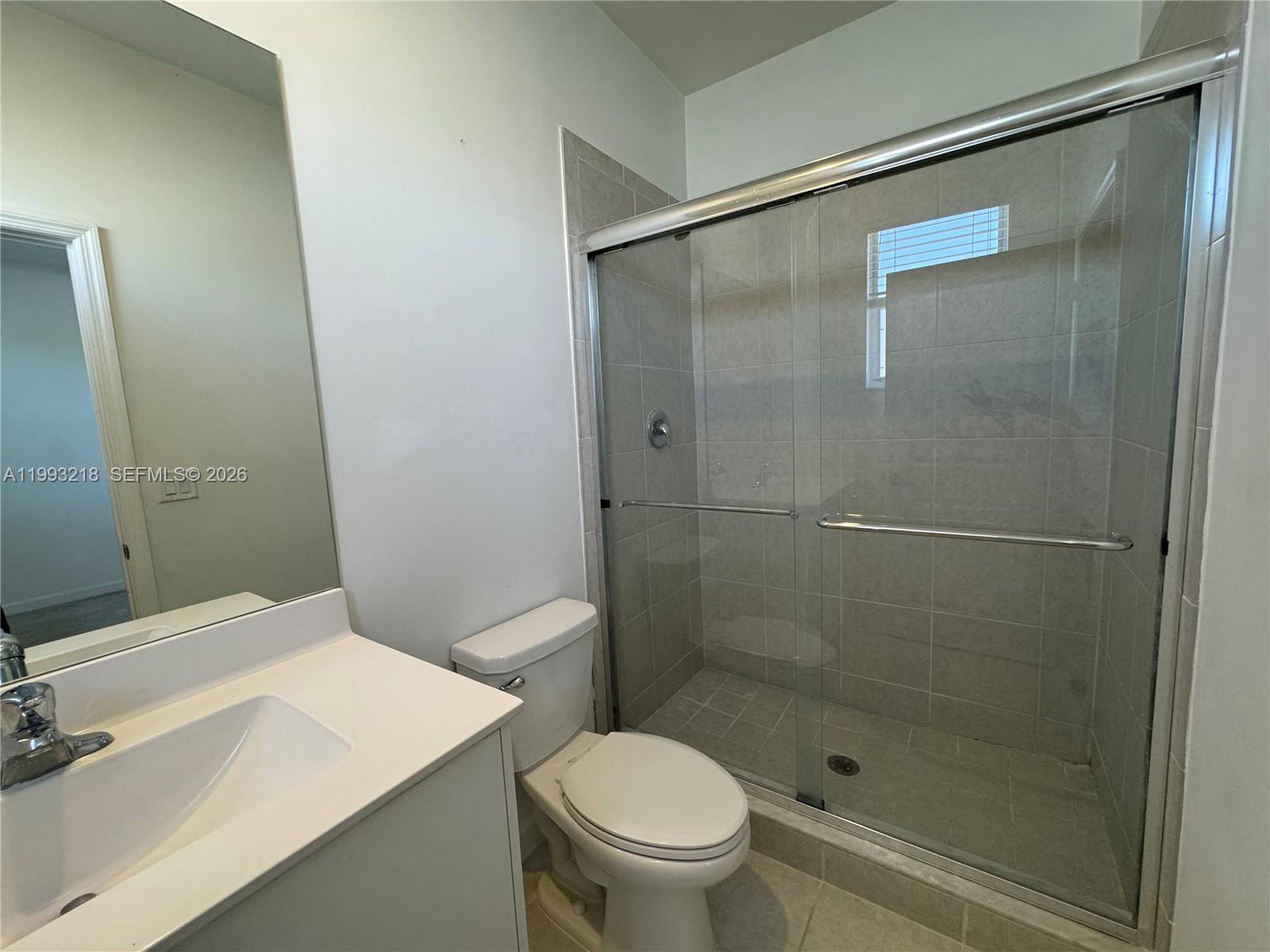 16227 Southwest 292nd Street Homestead, FL 33033 - Photo 25 of 28 a bathroom with a shower and a toilet