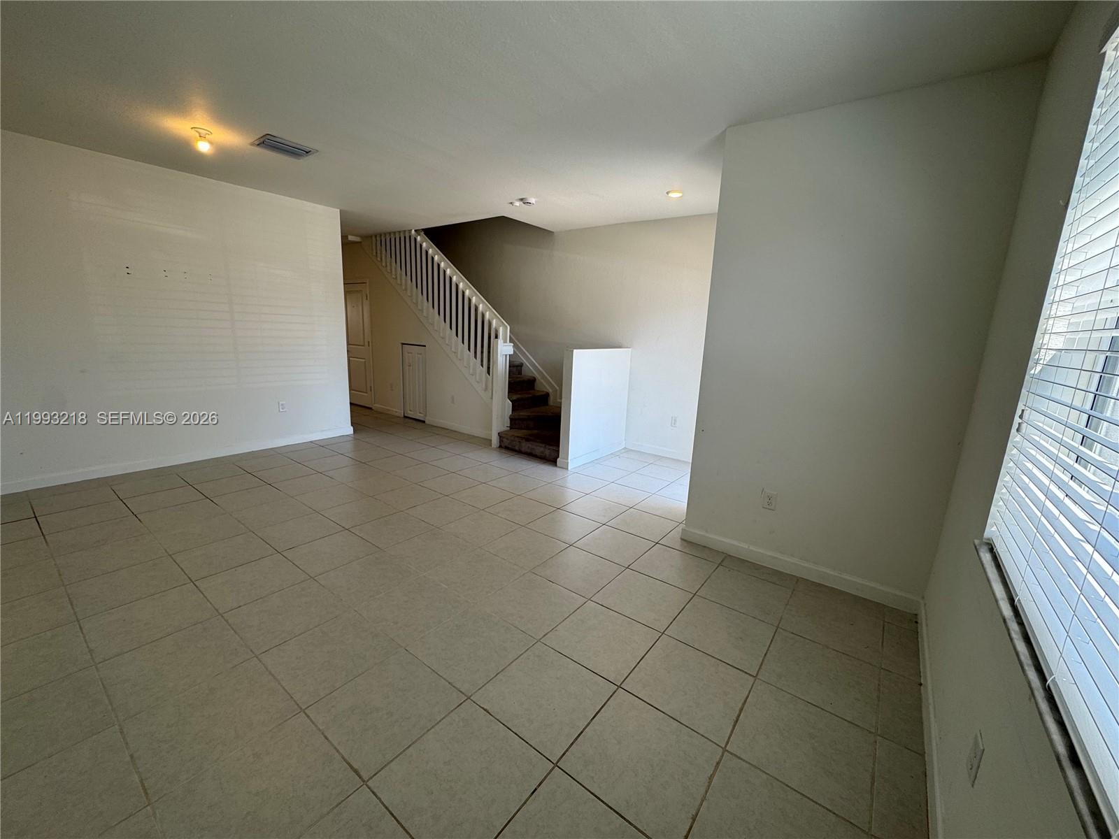 16227 Southwest 292nd Street Homestead, FL 33033 - Photo 5 of 28 an empty room with white walls