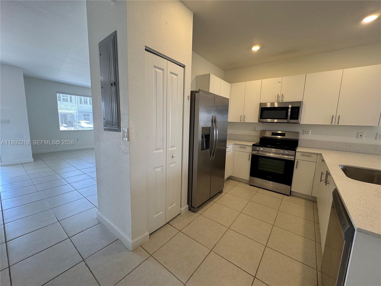 16227 Southwest 292nd Street Homestead, FL 33033 - Photo 6 of 28 a kitchen with stainless steel appliances granite countertop a refrigerator and a sink