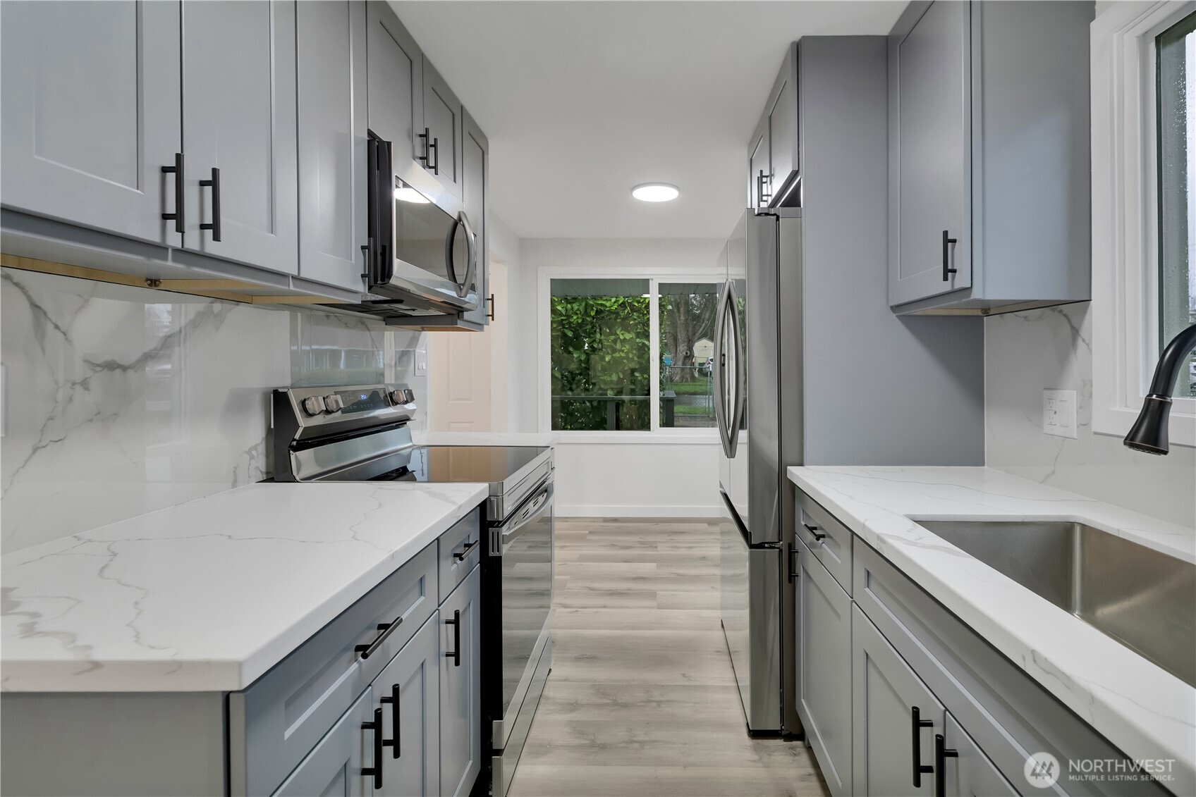 17017 4th Avenue Northeast Shoreline, WA 98155 - Photo 14 of 28 a kitchen that has a sink and a stove in it