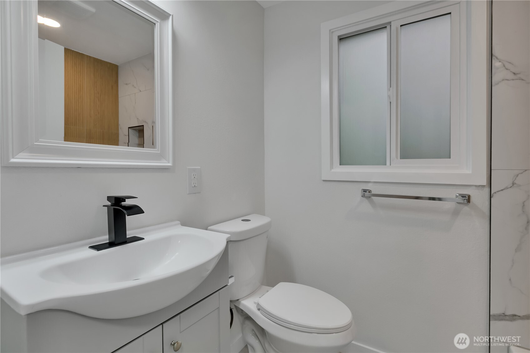 17017 4th Avenue Northeast Shoreline, WA 98155 - Photo 18 of 28 a bathroom with a toilet a sink and mirror