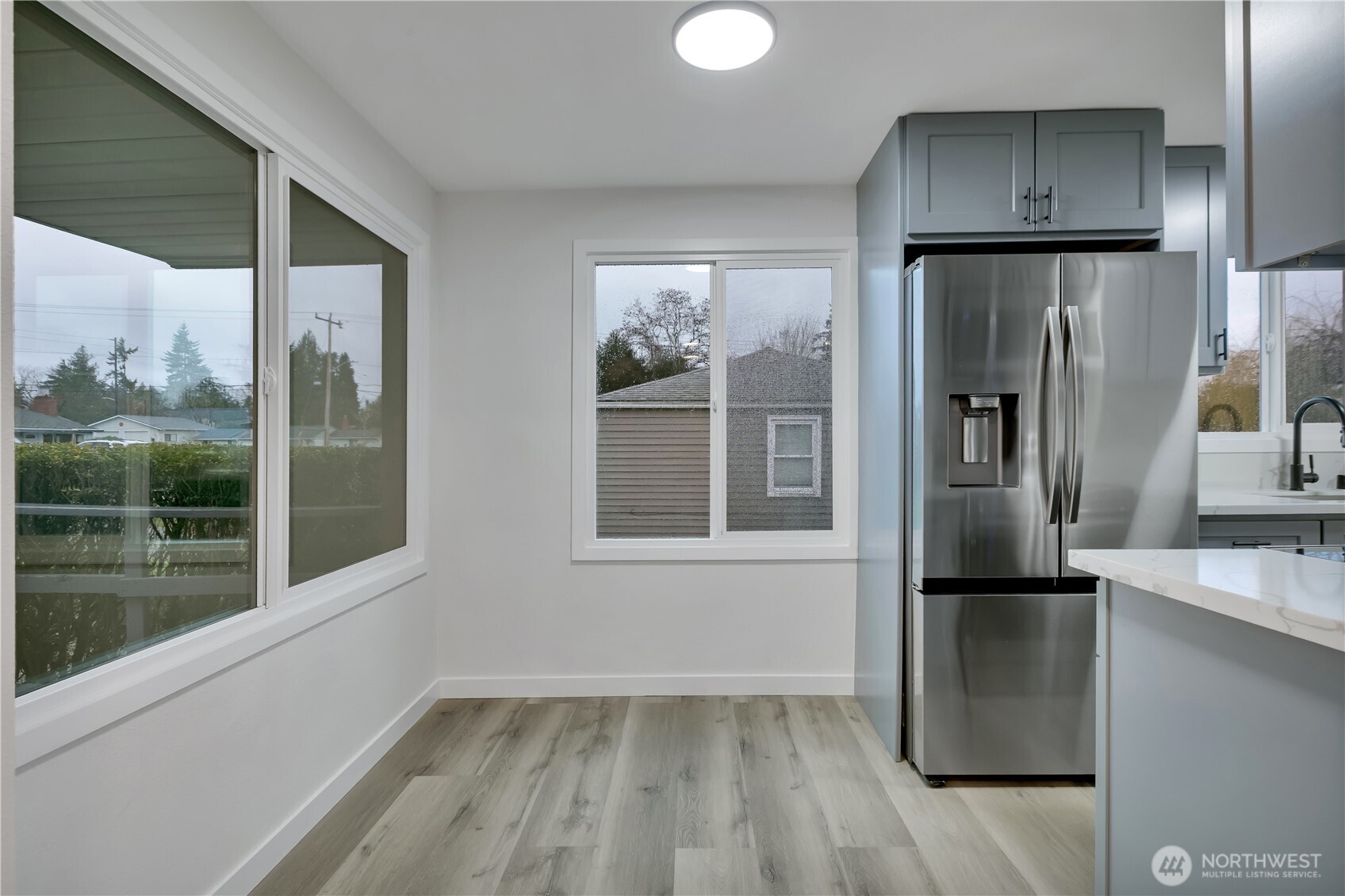 17017 4th Avenue Northeast Shoreline, WA 98155 - Photo 9 of 28 a kitchen with a refrigerator and wooden floor