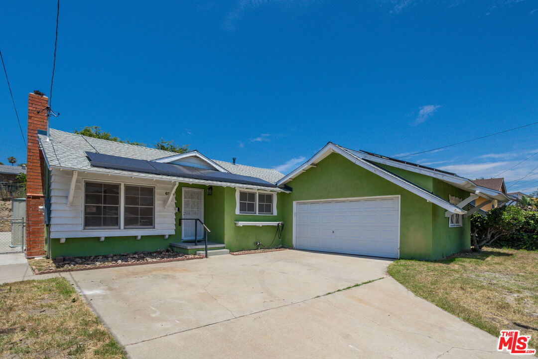 6352 Clyde Avenue San Diego, CA 92139 - Photo 1 of 30 a front view of a house with a garden and garage