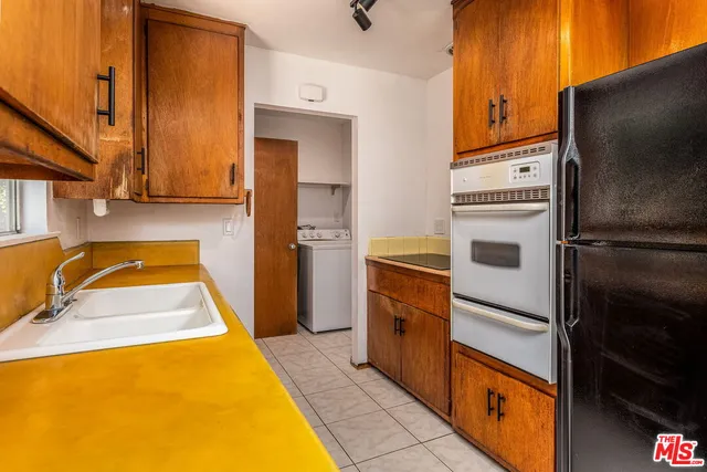 a kitchen with a refrigerator sink and stove