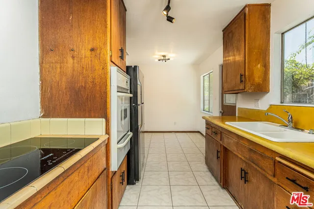 a kitchen with a sink and a refrigerator