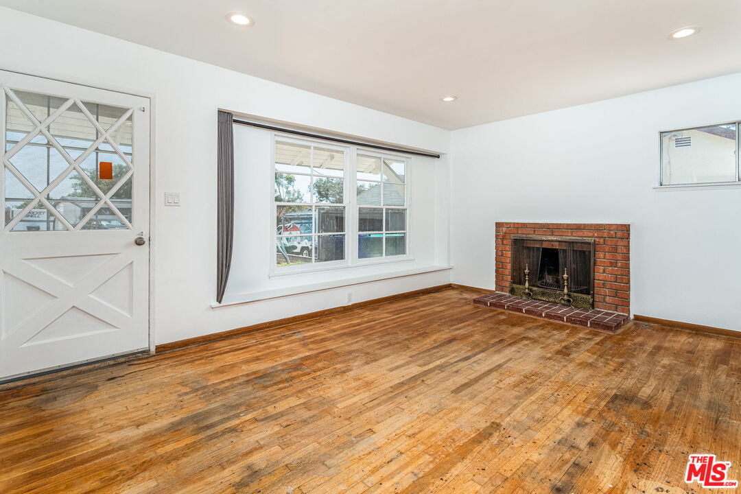 6352 Clyde Avenue San Diego, CA 92139 - Photo 8 of 30 a view of an empty room with wooden floor and a window
