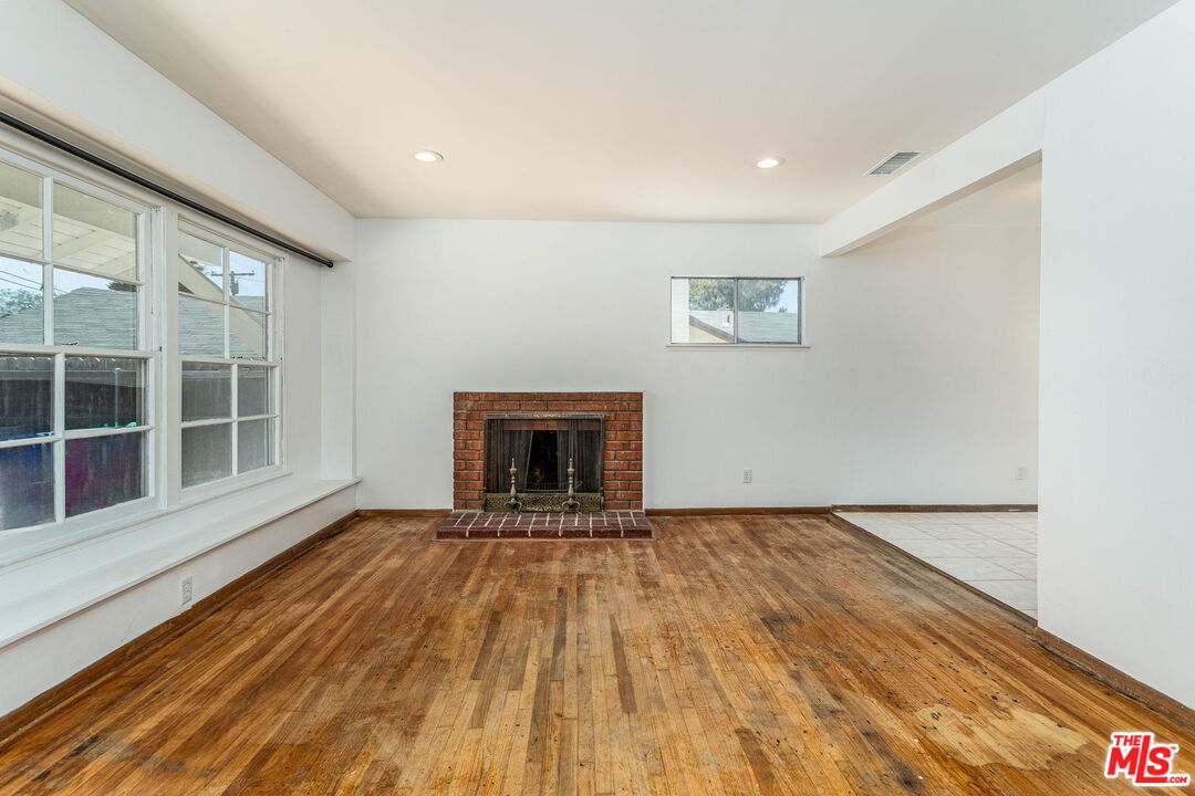 6352 Clyde Avenue San Diego, CA 92139 - Photo 9 of 30 a view of an empty room with wooden floor and a window