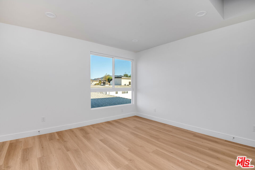 10803 Kling Street Toluca Lake, CA 91602 - Photo 13 of 25 a view of an empty room with wooden floor