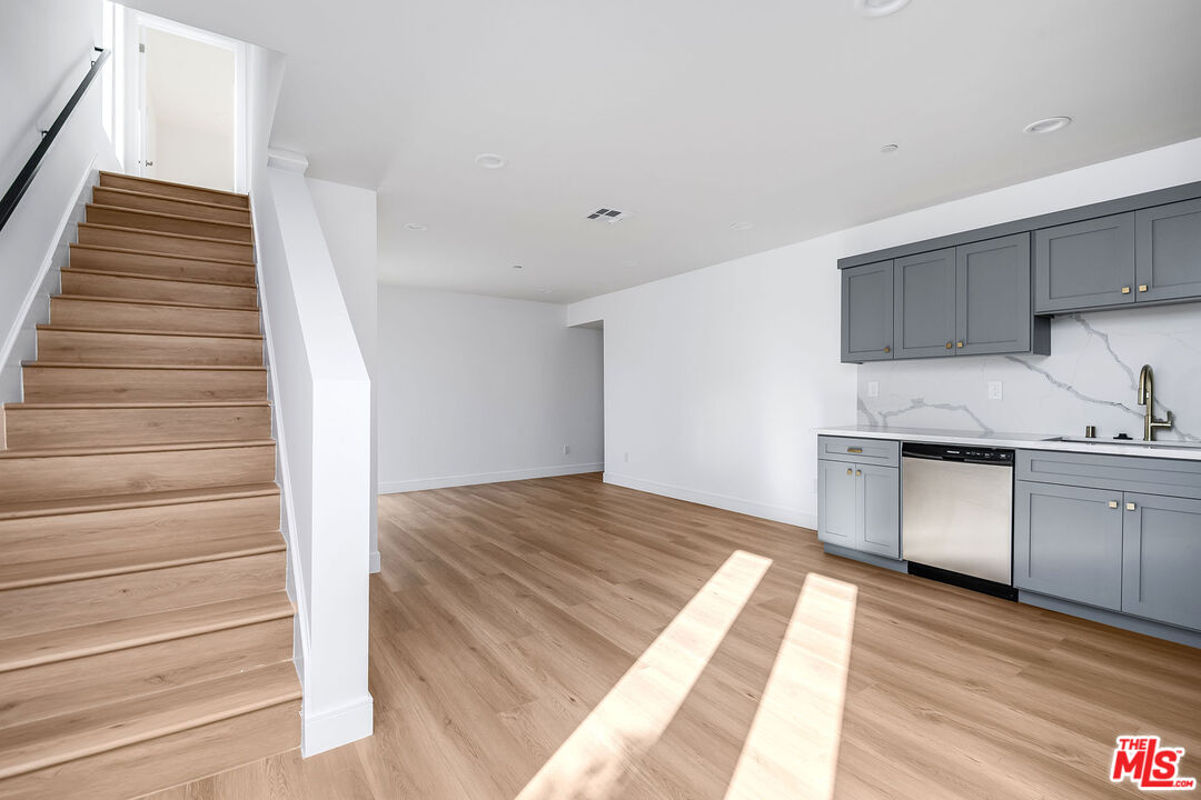 10803 Kling Street Toluca Lake, CA 91602 - Photo 22 of 25 a kitchen with granite countertop white cabinets and white appliances