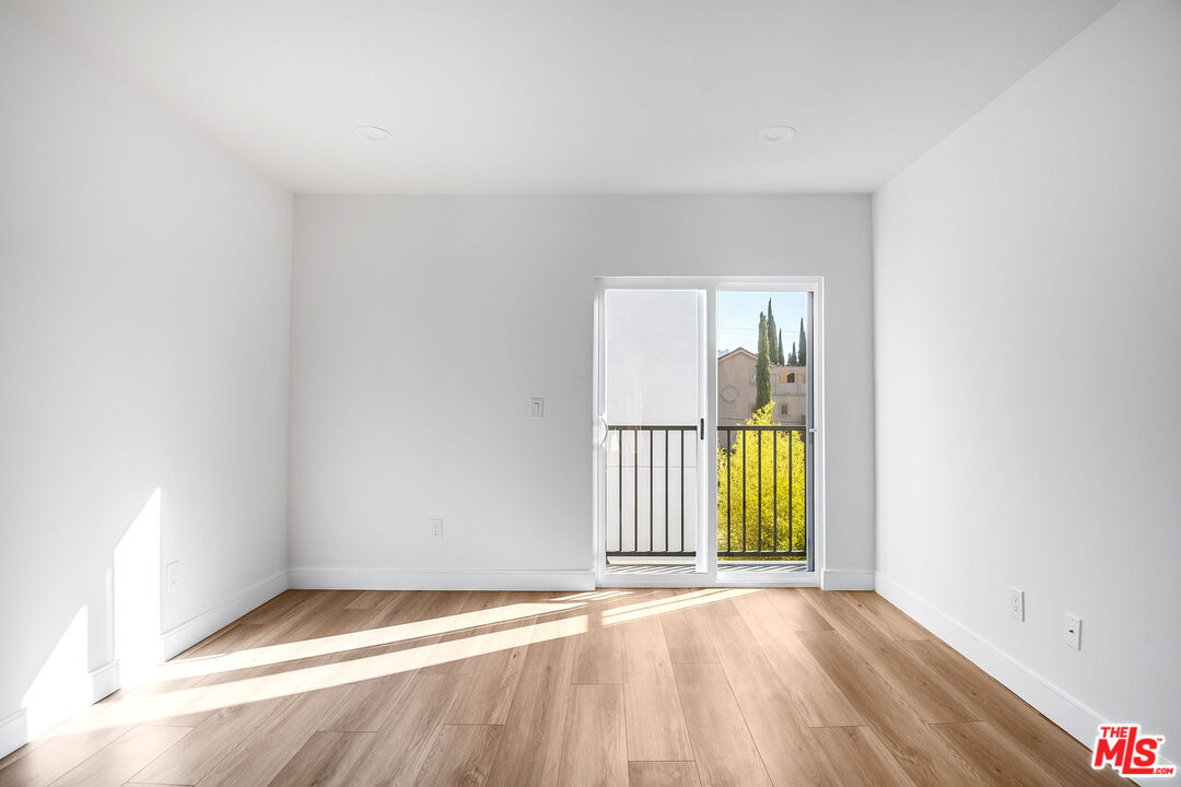 10803 Kling Street Toluca Lake, CA 91602 - Photo 24 of 25 an empty room with windows
