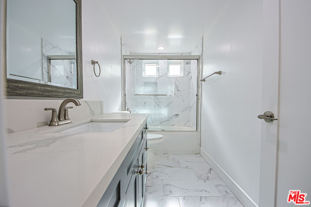 10803 Kling Street Toluca Lake, CA 91602 - Photo 9 of 25 a bathroom with a sink and a mirror