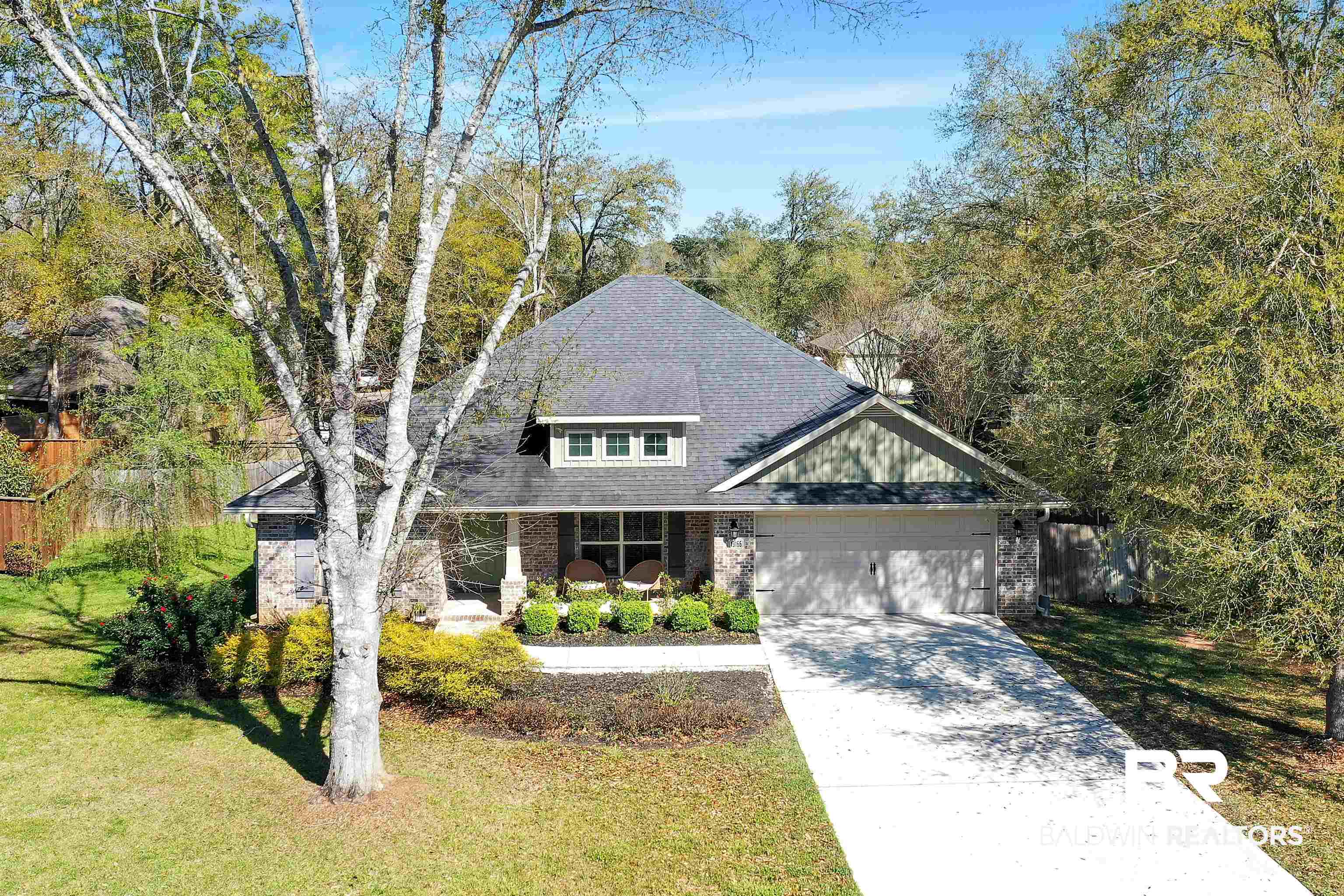 13166 Hulbert Court Foley, AL 36535 - Photo 5 of 27 View of front of home featuring a garage, concrete driveway, brick siding, a front lawn, and a porch
