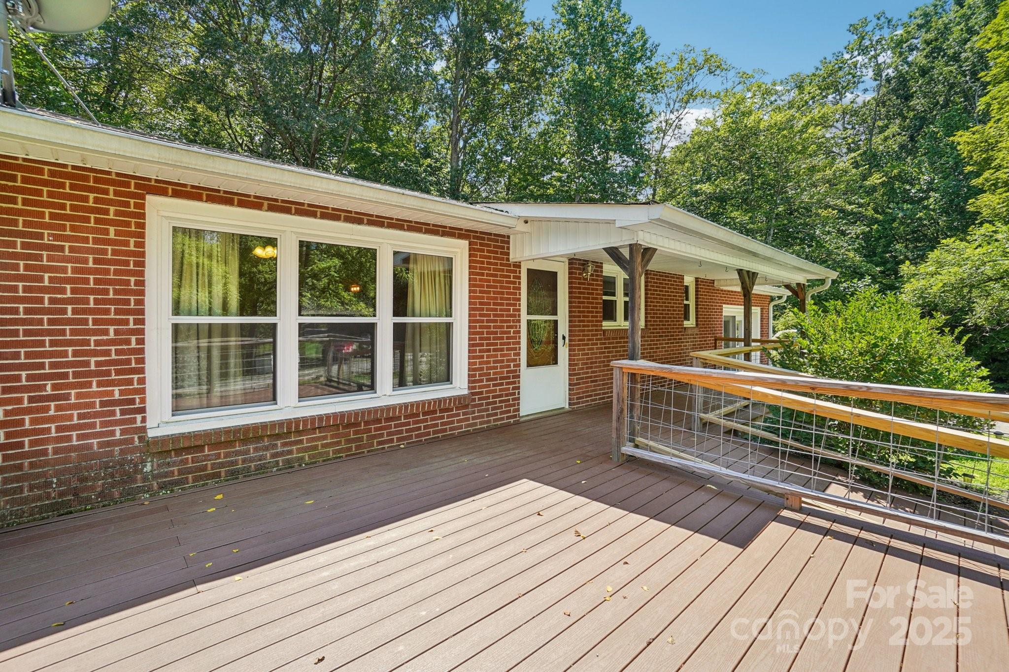 623 Edwards Cove Road Waynesville, NC 28786 - Photo 12 of 46 a view of a house with a roof deck