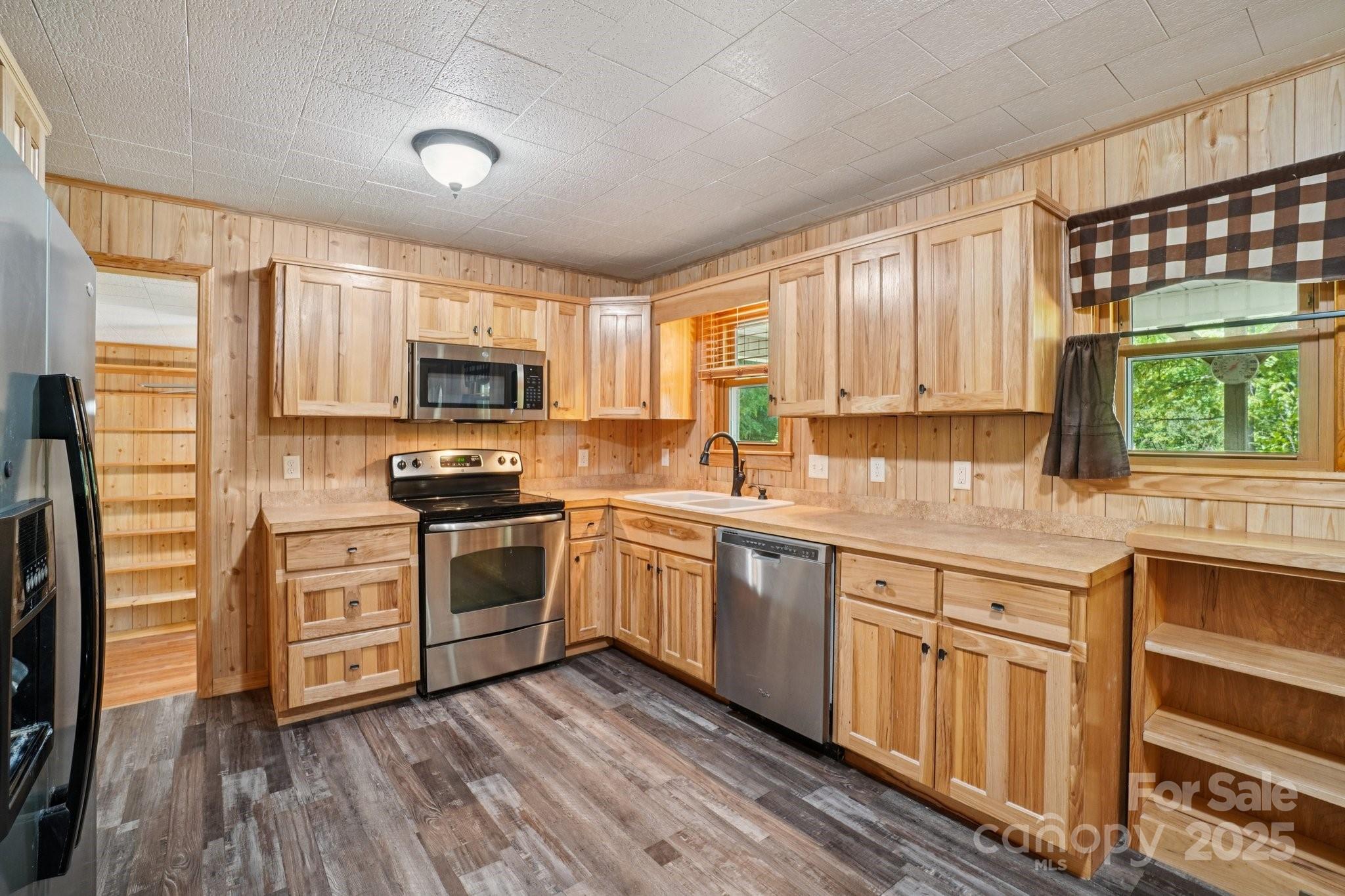 623 Edwards Cove Road Waynesville, NC 28786 - Photo 15 of 46 a kitchen with granite countertop a sink cabinets stainless steel appliances and a window