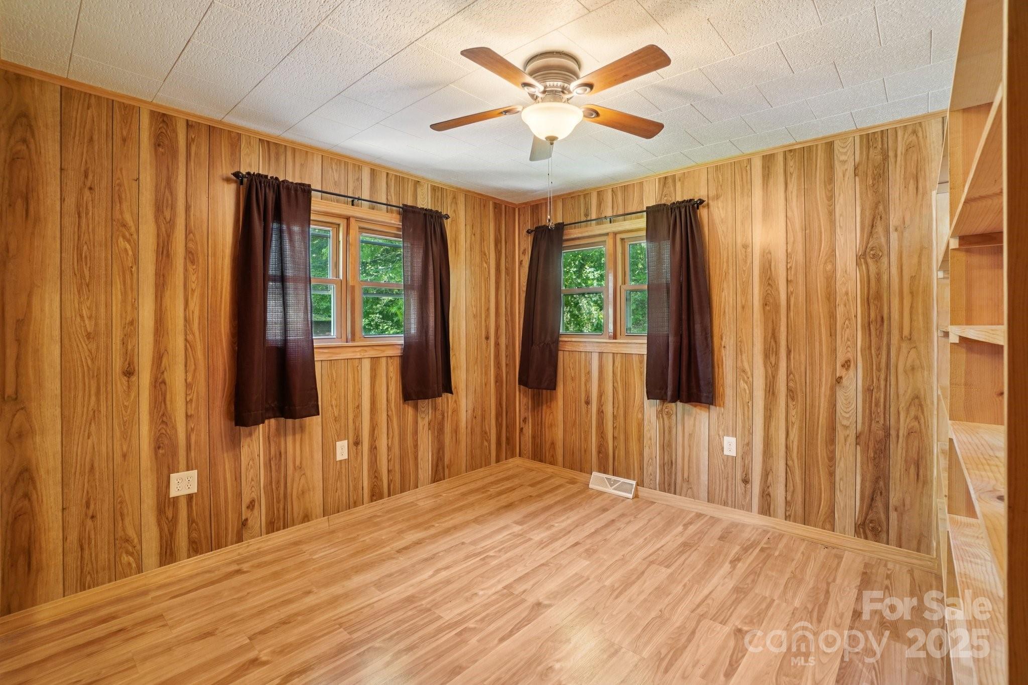 623 Edwards Cove Road Waynesville, NC 28786 - Photo 22 of 46 a bedroom with wooden floor and large window