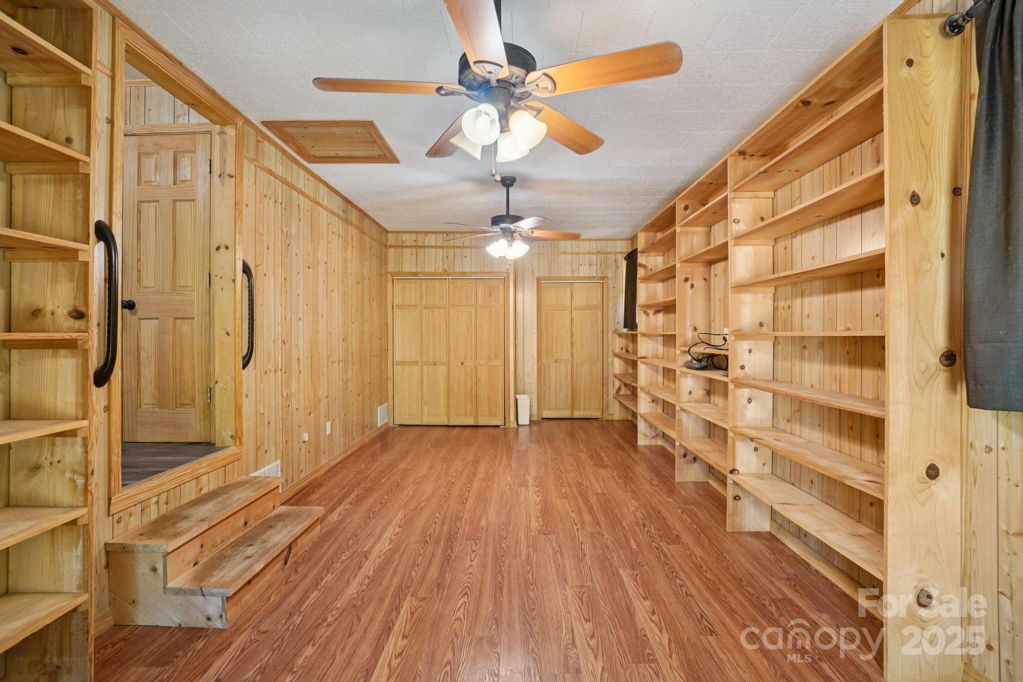 623 Edwards Cove Road Waynesville, NC 28786 - Photo 31 of 46 a view of a hallway with wooden floor and chandelier