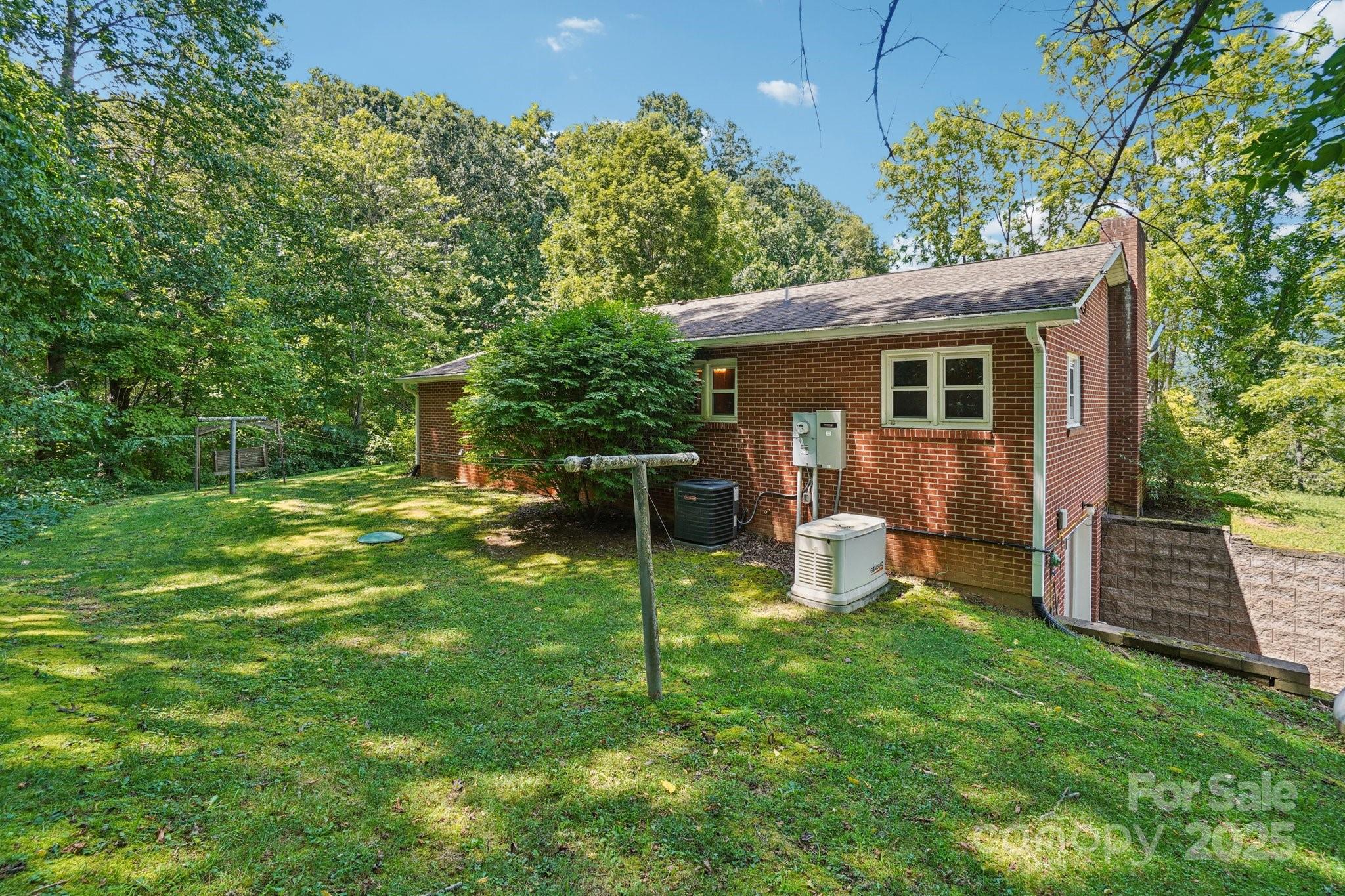 623 Edwards Cove Road Waynesville, NC 28786 - Photo 40 of 46 a view of a house with backyard and a tree