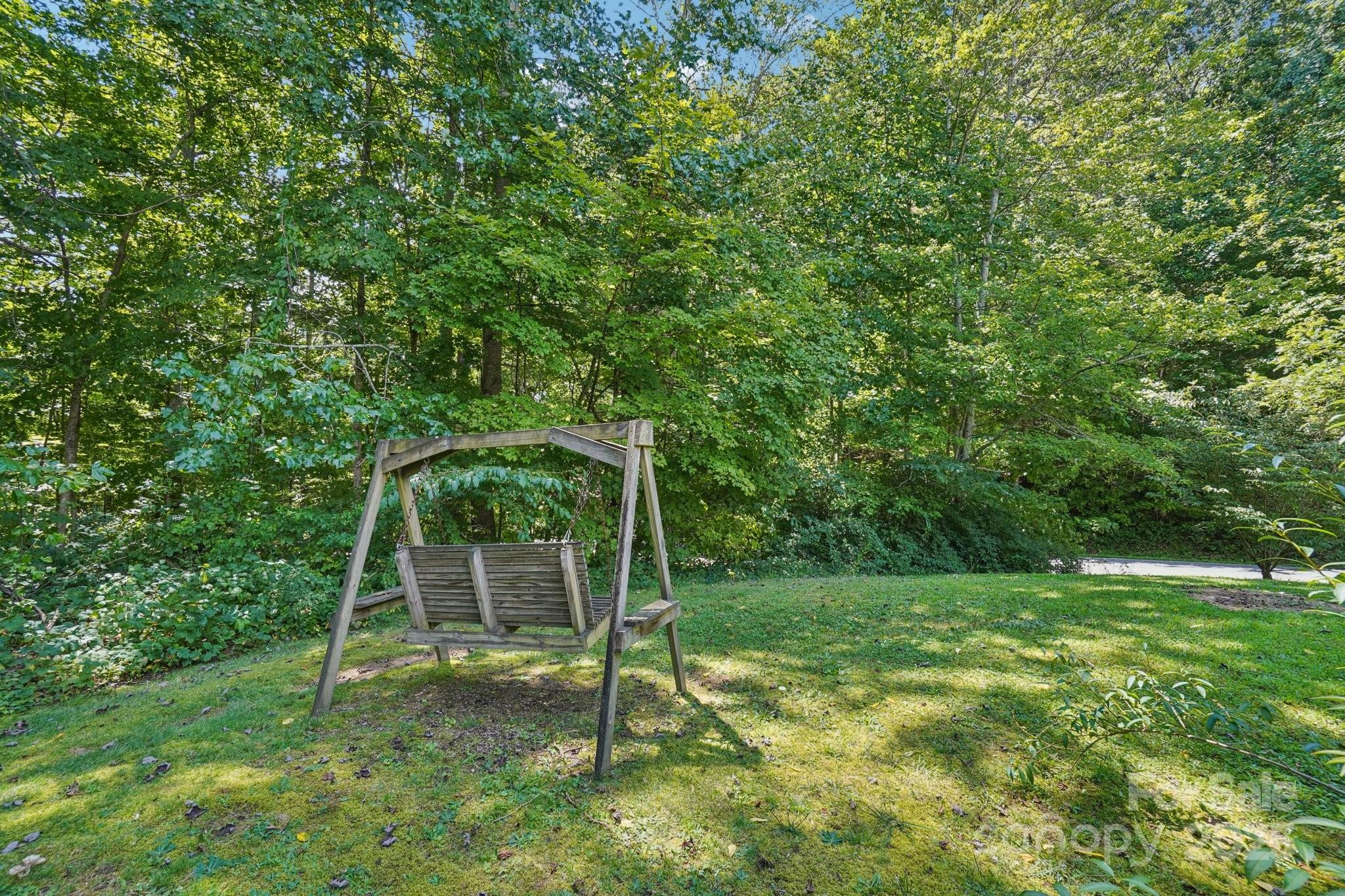 623 Edwards Cove Road Waynesville, NC 28786 - Photo 41 of 46 a backyard of a house with a table and chair