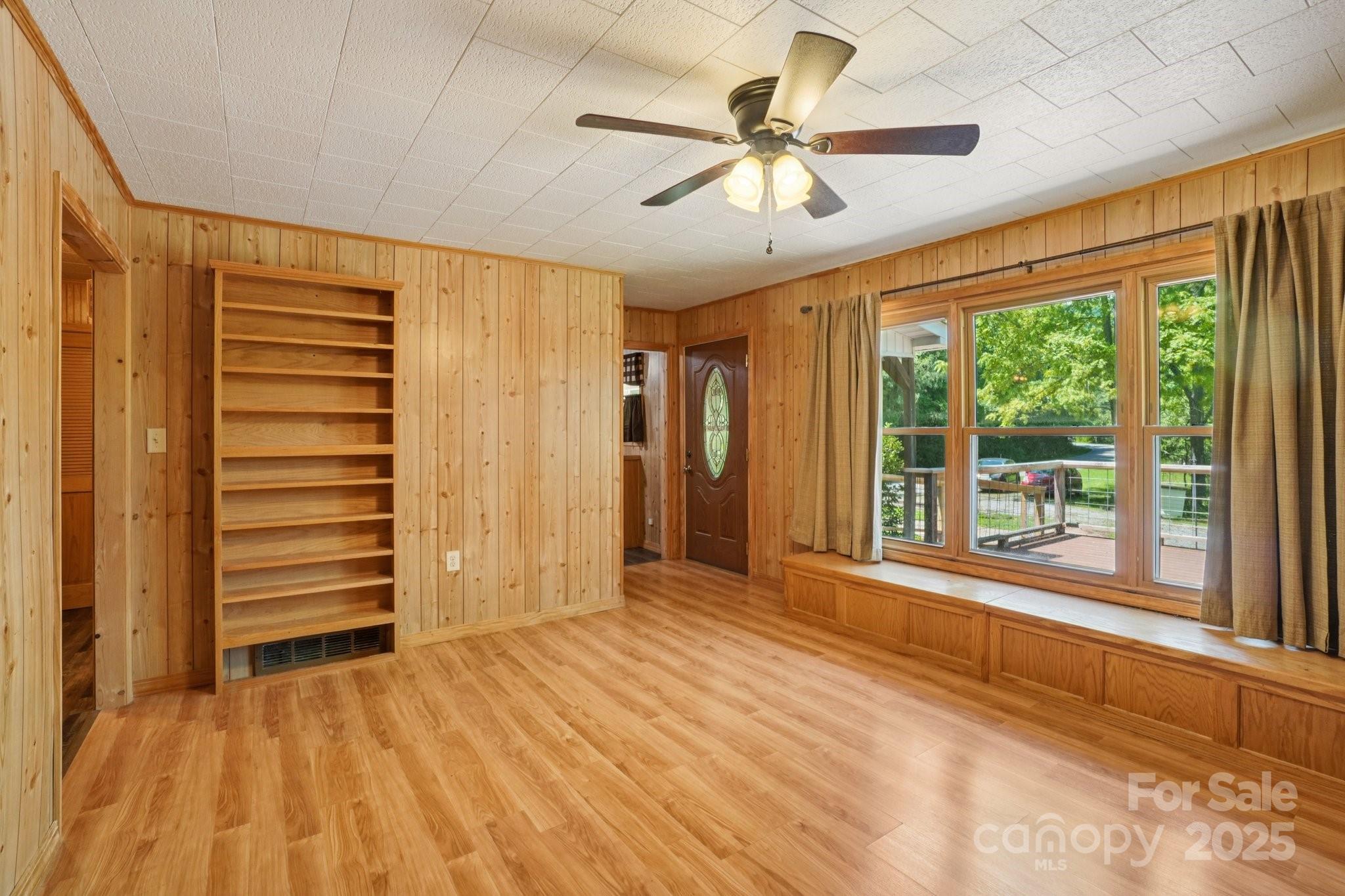 623 Edwards Cove Road Waynesville, NC 28786 - Photo 8 of 46 a view of an empty room with a window and a kitchen