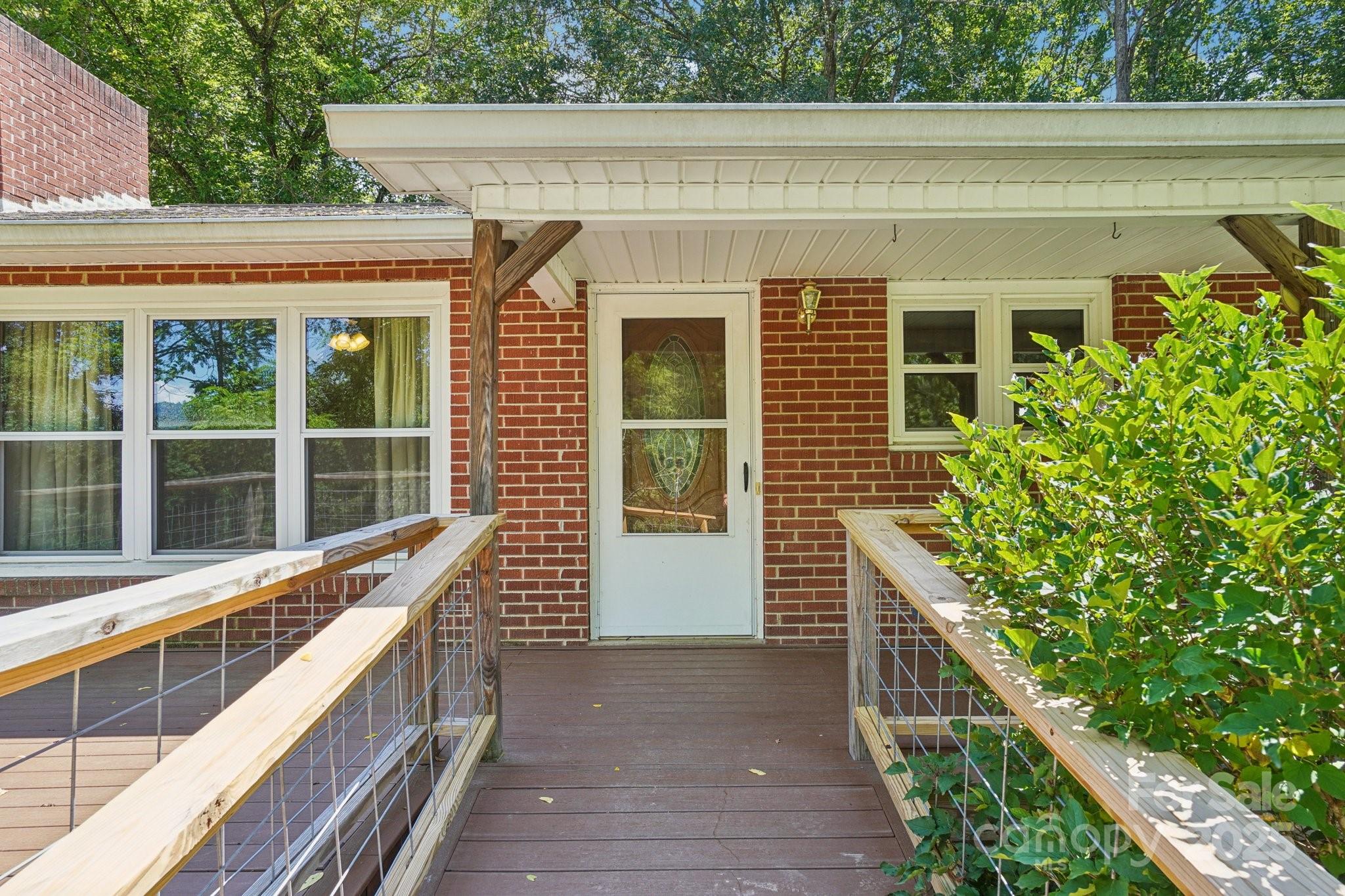 623 Edwards Cove Road Waynesville, NC 28786 - Photo 9 of 46 a view of a balcony with two windows