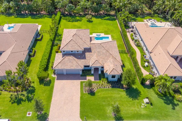 an aerial view of a house with a garden and swimming pool