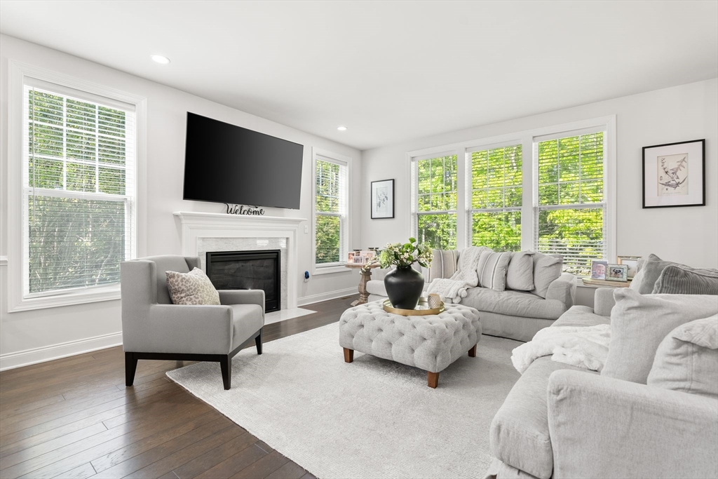 2 Hummingbird Way, Unit 1 Methuen, MA 01844 - Photo 9 of 42 a living room with furniture a flat screen tv and a fireplace