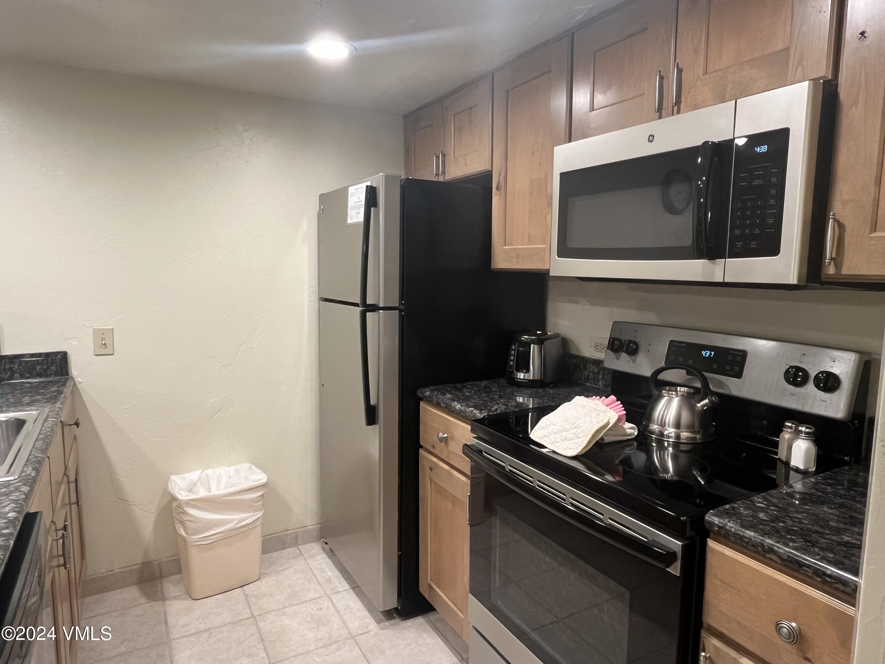1020 Vail View Drive, Unit 330549 Vail, CO 81657 - Photo 2 of 21 a kitchen with stainless steel appliances a stove a microwave and a refrigerator