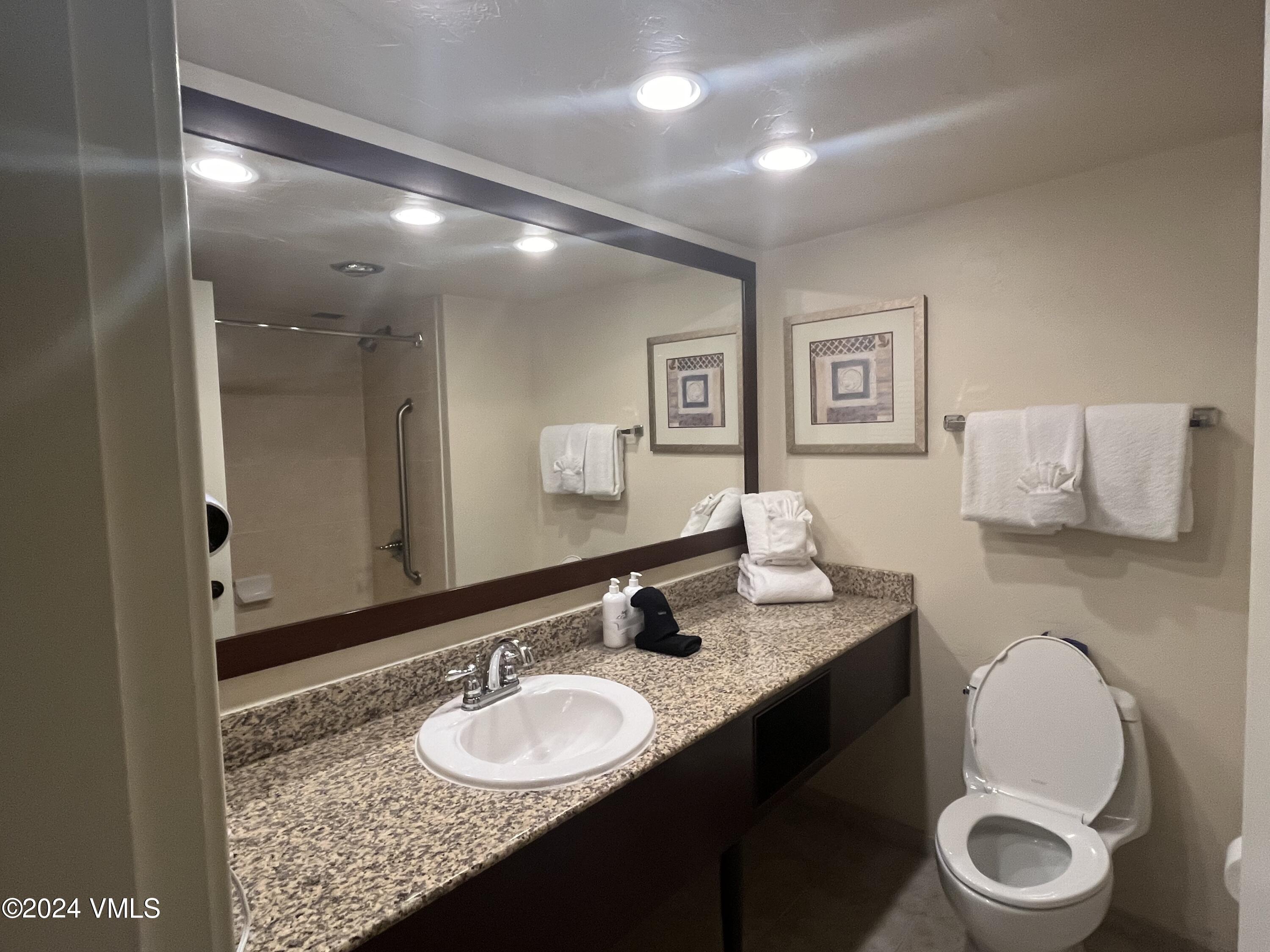 1020 Vail View Drive, Unit 330549 Vail, CO 81657 - Photo 9 of 21 a bathroom with a granite countertop sink and a mirror