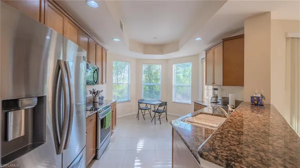 a living room with fireplace furniture and a large window