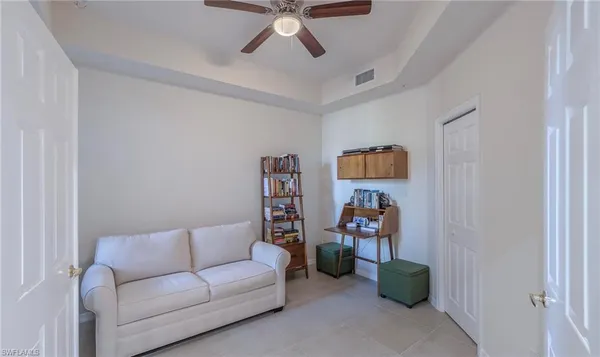 a living room with furniture and gym equipment